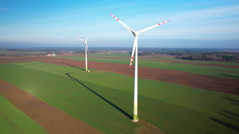 Rotating-wind-turbines-in-Polish-farmland-on-Spring-Sunny-Day