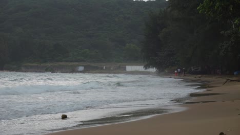 Sandy-beach-Dam-Trau-Beach-Waves-rolling-into-Seashore-On-A-Cloudy-Day-In-Con-Dao,-Vietnam