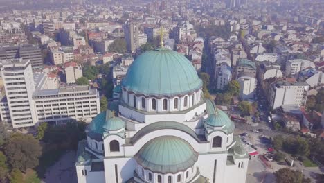 Slow-orbiting-aerial-shot-of-dome-and-cross-of-Saint-Sava-Temple,-Belgrade
