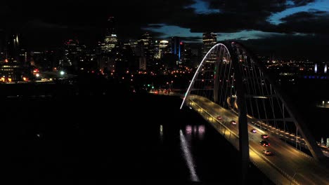 Aerial-drone-view-of-the-Edmonton-Walterdale-Bridge-over-the-North-Saskatchewan-River-during-a-summer-night-and-the-downtown-skyline-in-the-background