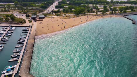 aerial-drone-footage-of-a-beautiful-sandy-Chicago-beach-during-a-sunny-afternoon-in-the-city