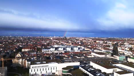 Rainbow-in-sky-grey-Cloud-formation-over-city-berlin-district-mitte-center