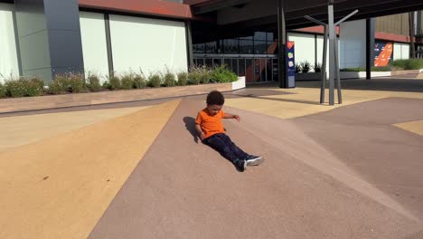 Persistent-3-year-old-black-child-enjoying-climbing-and-sliding-in-a-playground
