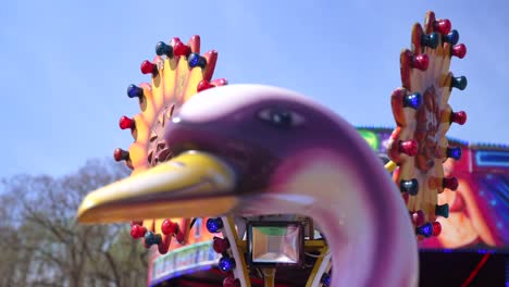 Slow-motion-colourful-flashing-sun-decorations-rotating-on-children's-funfair-carousel-ride