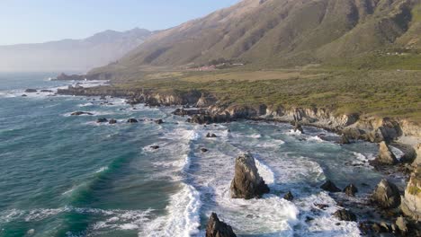 Elevated-view-of-waves-rolling-over-jutting-rocks-to-shore-the-Pacific-Ocean-located-in-Big-Sur-California