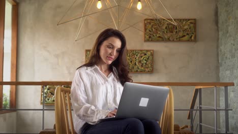 Young-adult-business-woman-typing-on-laptop-computer-working-from-home,-beautiful-female-professional-user-lady-using-technology-doing-remote-online-job-at-home