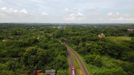 Aerial-view-of-a-train-running-on-rails-with-view-of-the-beautiful-rural-landscape