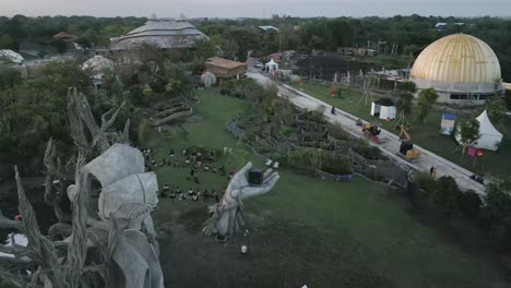 Unique-hand-and-face-statues-in-Bali-tropical-island-park,-aerial