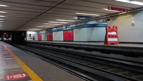 Slow-motion-shot-of-an-underground-train-approaching-the-underground-platform