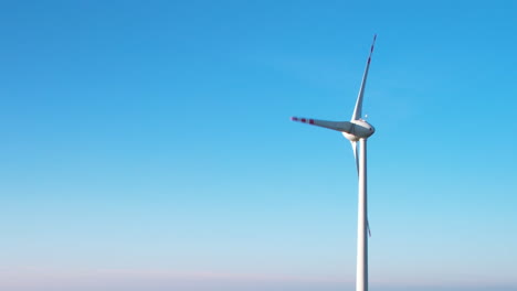 One-wind-turbine-against-clear-blue-sky---clean-energy-concept
