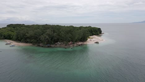 Aerial-descends-to-beachfront-huts-on-tropical-Gili-Nangg-on-Lombok