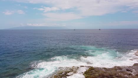Vast-ocean-seascape-with-waves-crashing-against-rocky-volcanic-coast-in-Tenerife