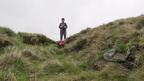 Young-boy-outdoors-on-the-moors-playing-with-his-RC-Car,-Truck,-4-x-4