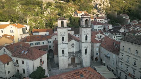 Drone-panning-shot-of-the-high-church-towers-of-the-St-Tryphon-cathedral-in-Kotor