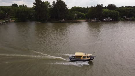 Aerial-tracking-shot-of-cruising-Taxi-boat-Delta-del-Parana-River-in-Buenos-Aires