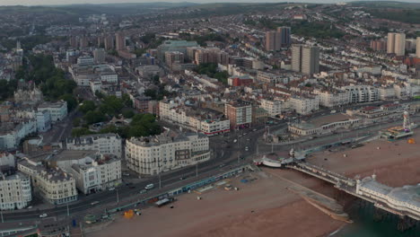 Pan-down-aerial-shot-over-Brighton-Marine-parade-road-roundabout-at-dusk