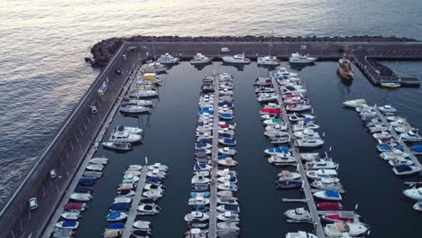 View-at-boats-docked-in-calm-marina-of-Los-Gigantes,-Tenerife