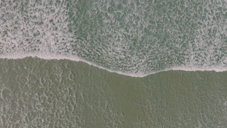 Overhead-View-Of-Waves-Splashing-Onto-Shoreline-In-Razo-Beach,-Carballo,-Spain