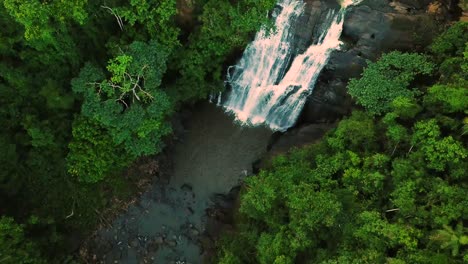 Incredible-establishing-tilting-aerial-shot-of-stunning-waterfall-in-wild-jungle,-Minas-Gerais-Brazil