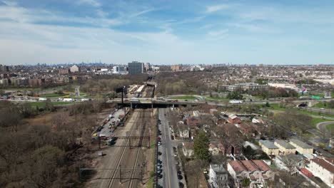 An-aerial-view-of-a-train-traveling-in-The-Bronx,-in-New-York-on-a-sunny-morning