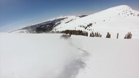 Male-Snowboarder-GoPro-follow-backcountry-powder-slow-motion-cinematic-mid-winter-fresh-snow-blue-skies-Colorado-at-Vail-Pass-early-morning