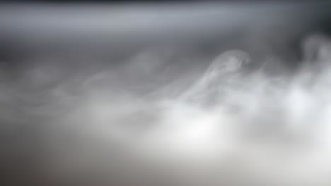 Thick-white-fog-smoke-spreads-even-across-black-grey-surface-background