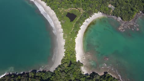 Drone-view-rising-over-double-sand-tropical-beach,-Manuel-Antonio,-Costa-Rica