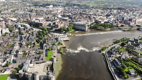 Cinematic-Aerial-View-of-Limerick-City,-Ireland,-Shannon-River-Estuary-Buildings-and-Downtown-on-Summer-Day,-Drone-Shot