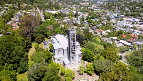 Beautiful-aerial-of-iconic-Christ-Church-Cathedral-and-Nelson-city-downtown,-summer-sunny-day-in-New-Zealand