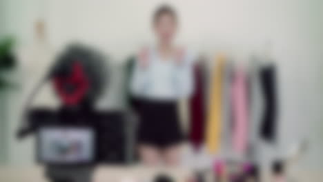 Blurred-shot-of-female-fashion-influencer-creating-wardrobe-style-video-content,-grwm-concept