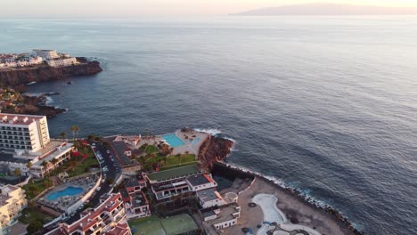Aerial-view,-charming-coastal-town,-tourist-resorts-and-port-Los-Gigantes