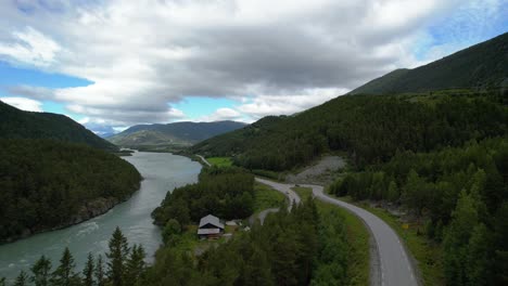 Road-among-the-mountains-and-a-stormy-river-in-Norway