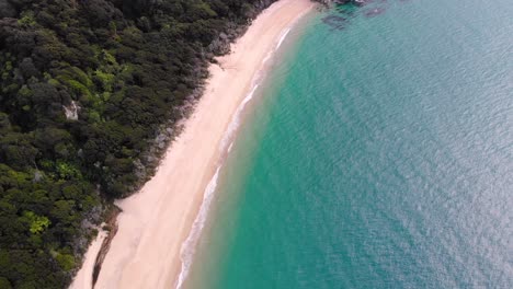 Long-sandy-beach-and-tropical-paradise-scenery-aerial-birds-eye-view