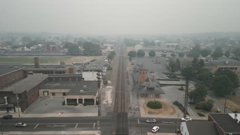 Aerial-drone-view-of-train-station-in-thick-smog-and-haze