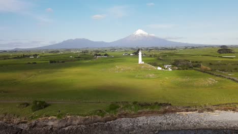 Cape-Egmont-Lighthouse-and-Taranaki-Volcano-in-New-Zealand---spectacular-aerial-flyover-popular-scenic-attraction