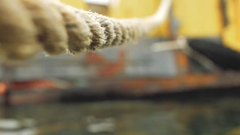 Close-up-of-the-rope-of-a-ship-moored-at-a-dock,-maritime-transportation-background,-selective-focus