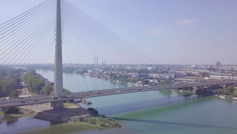 Establishing-slow-descending-aerial-shot-of-Sava-river-and-Ada-bridge-in-Belgrade