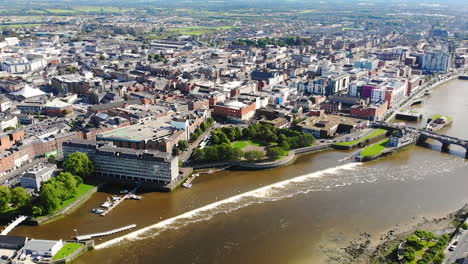 Aerial-View-of-Limerick-City,-Ireland,-Shannon-River,-Hunt-Museum-and-Bridges-on-Sunny-Summer-Day,-Pull-Back-Drone-Shot