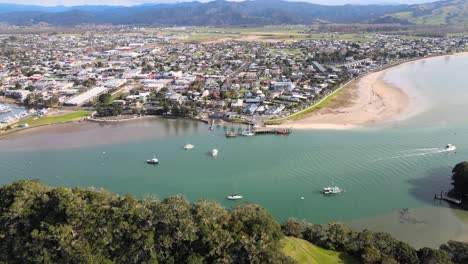 Aerial-panoramic-view-of-Whitianga-town-in-New-Zealand,-waterfront-with-ferry-port,-sunny-day