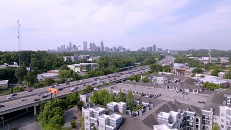 Atlanta,-Georgia-skyline-and-freeway-traffic-with-drone-video-moving-up