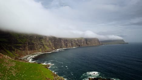 Aerial-Shot-Over-Green-Cliff-Reveals-Epic-Rocky-Scottish-Coast,-Isle-Of-Skye