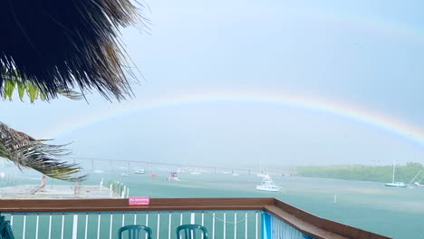 Colorful-double-rainbow-after-tropical-storm-over-water,-Marathon,-Florida-Keys