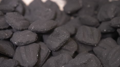 Macro-close-up-dolly-on-BBQ-charcoal-briquettes-in-smoker