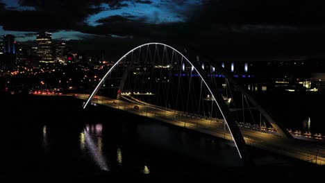 Aerial-drone-view-of-the-Edmonton-Walterdale-Bridge-over-the-North-Saskatchewan-River-during-a-summer-night-and-the-downtown-skyline-in-the-background