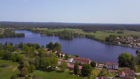 Smooth-aerial-top-view-flight-rural-village-Chlum-on-lake-in-czech-republic-Europe,-summer-day-of-2023