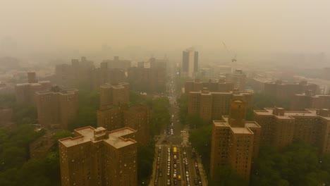 Aerial-view-backwards-over-the-East-135-Street-and-the-Park-Avenue-Bridge,-wildfire-haze-in-Harlem,-New-York,-USA