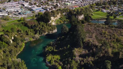 Amazing-aerial-tilt-up-over-Waikato-river-reveal-cityscape-of-Taupo