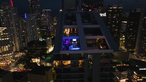 Aerial-wide-cityscape-shot-of-a-penthouse-apartment-during-night-in-Miami