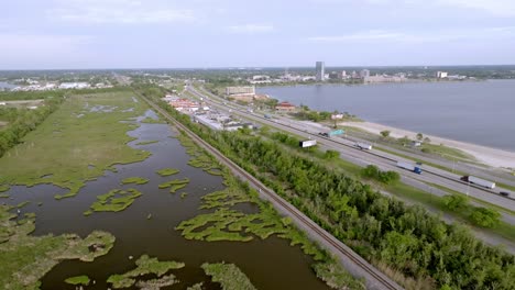 Wide-shot-of-Lake-Charles,-Louisiana-skyline-with-bayou-and-freeway