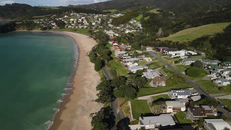 Aerial-view-of-small-settlement-beside-sandy-beach